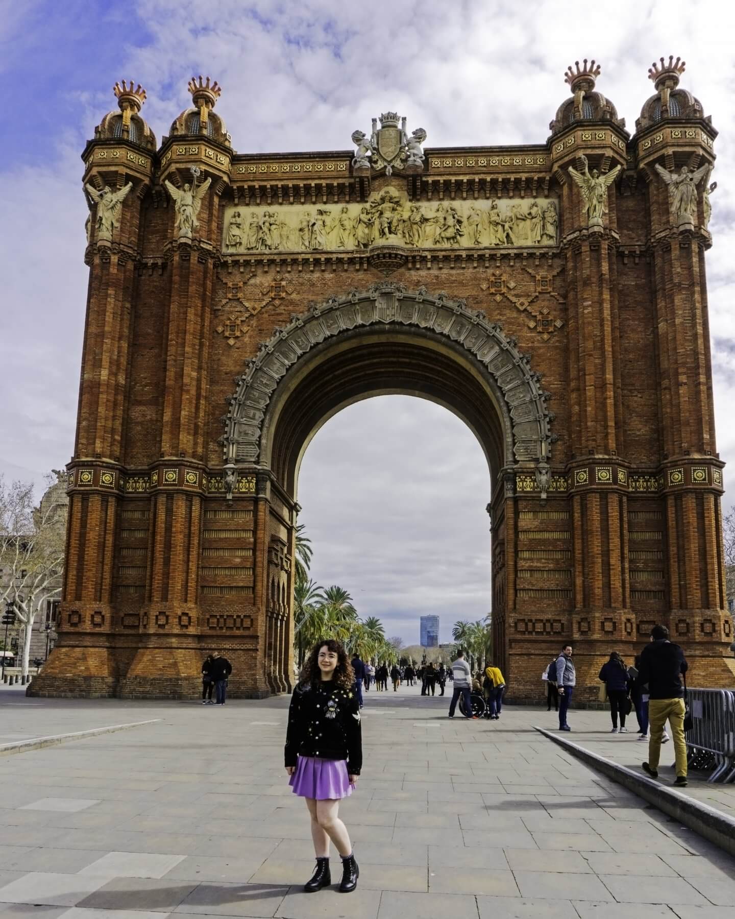 Girl standing by Arc de Triomf in Barcelona, Spain