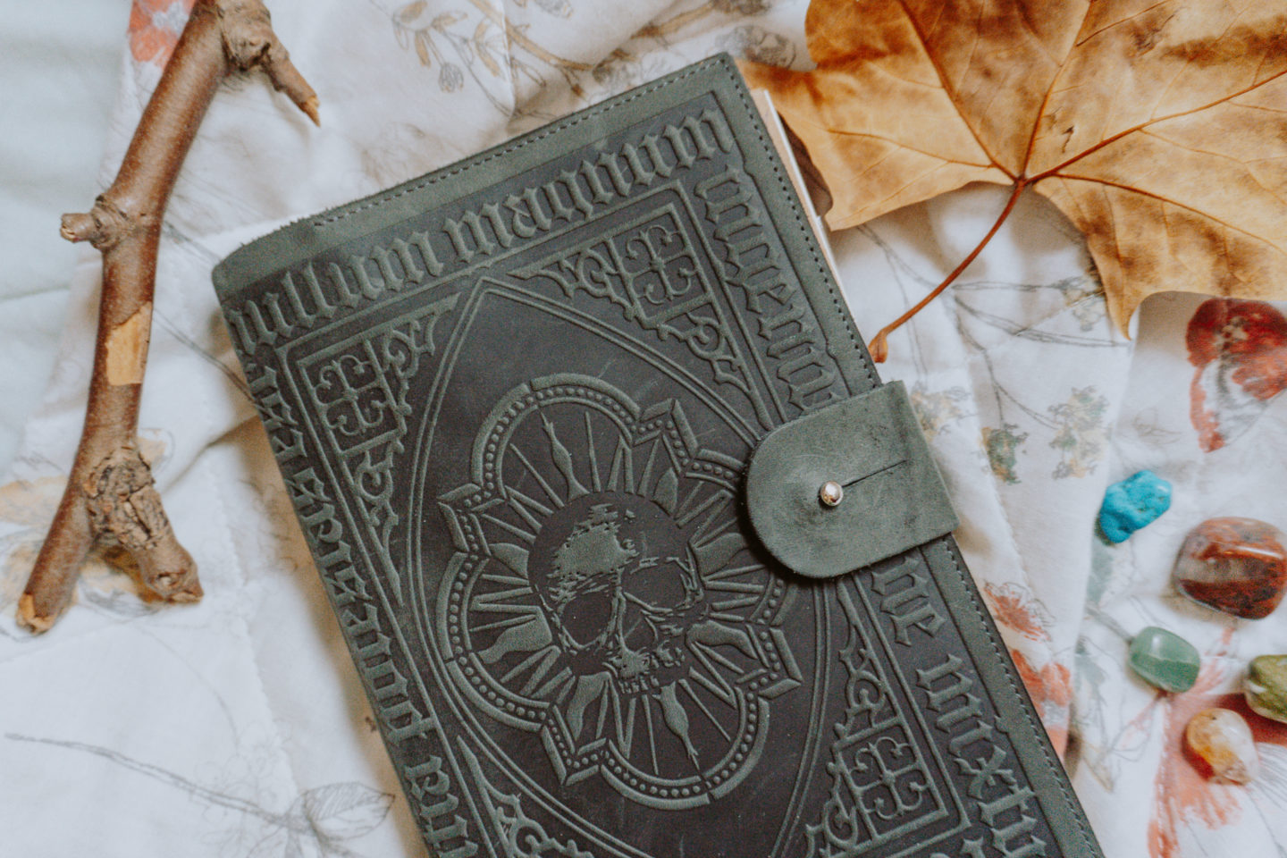 leatherbound journal with skull, crystals, autumn leaf