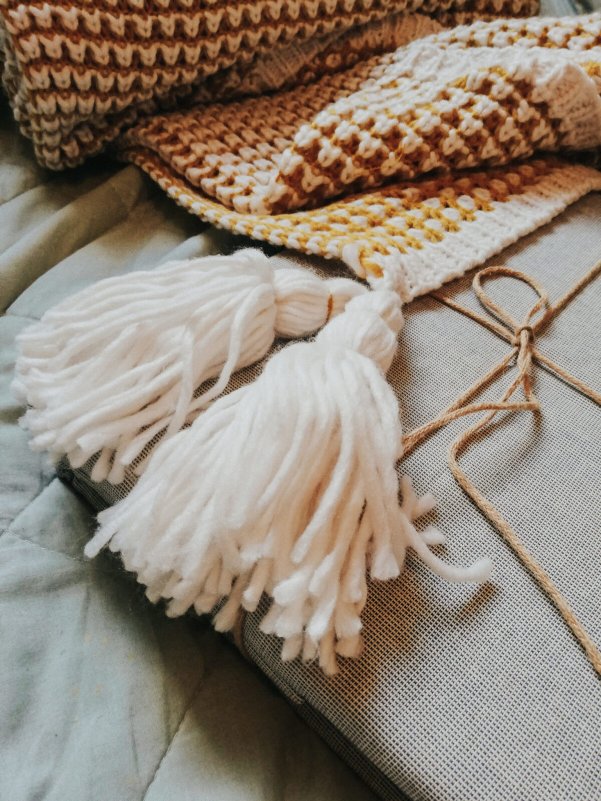 Mustard yellow tassel throw and recycled bedding from TK Maxx. Great Mother's Day Gift Ideas!