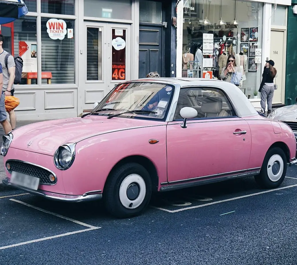 A vintage pink car in Notting Hill, London. 