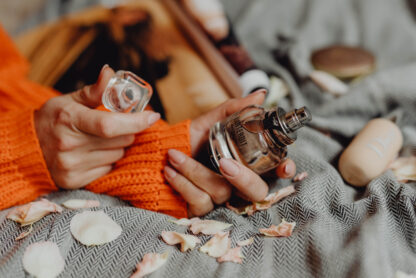 woman holding bottle of givenchy perfume