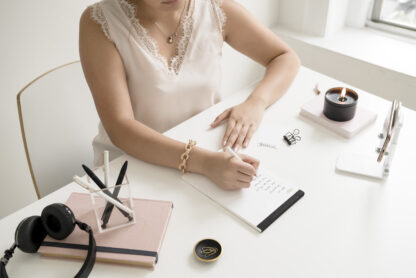 female entrepreneur writing at desk