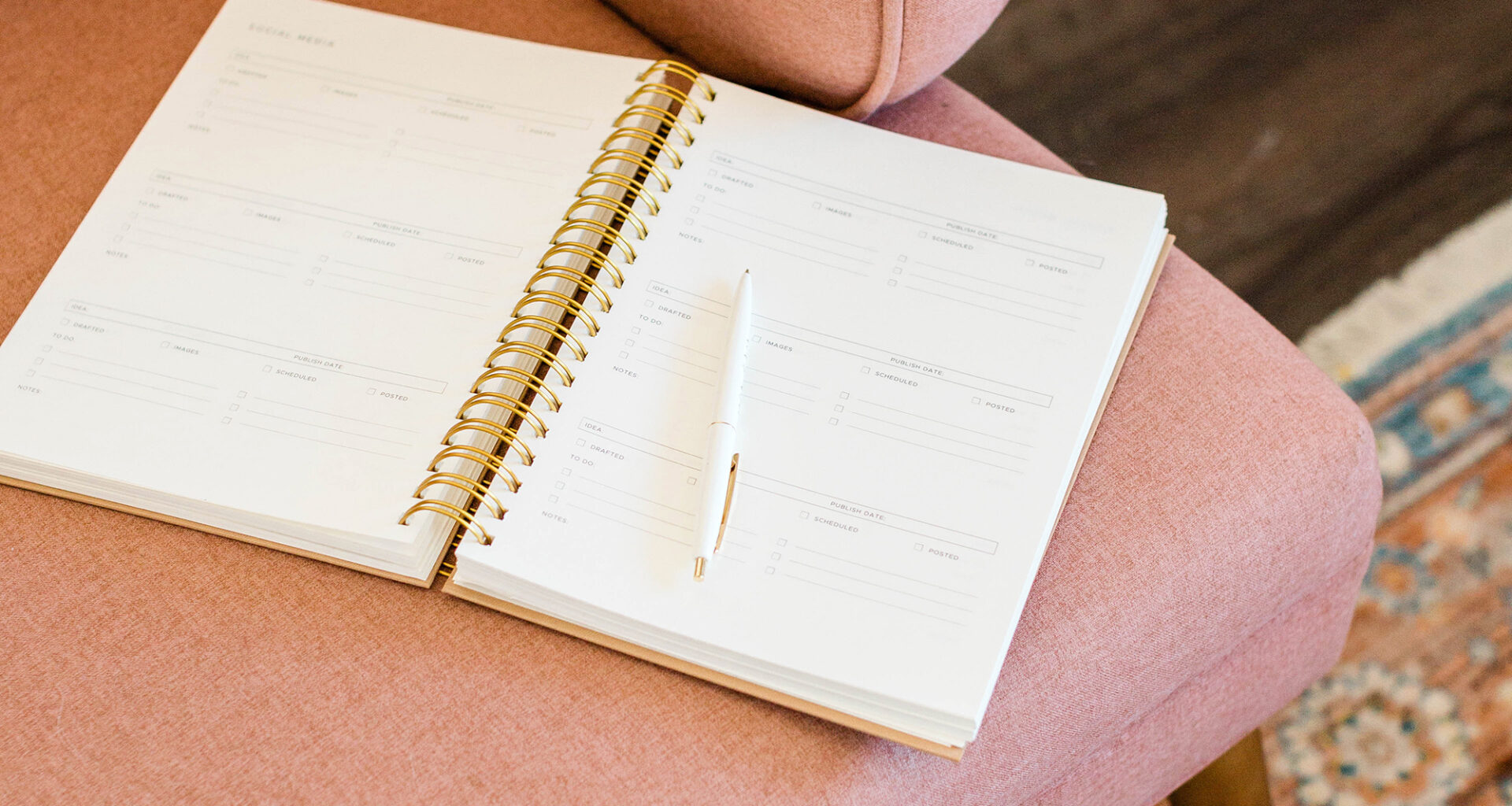 open notebook/journal on pink chair at home