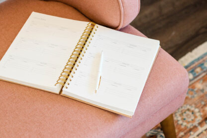 open notebook/journal on pink chair at home