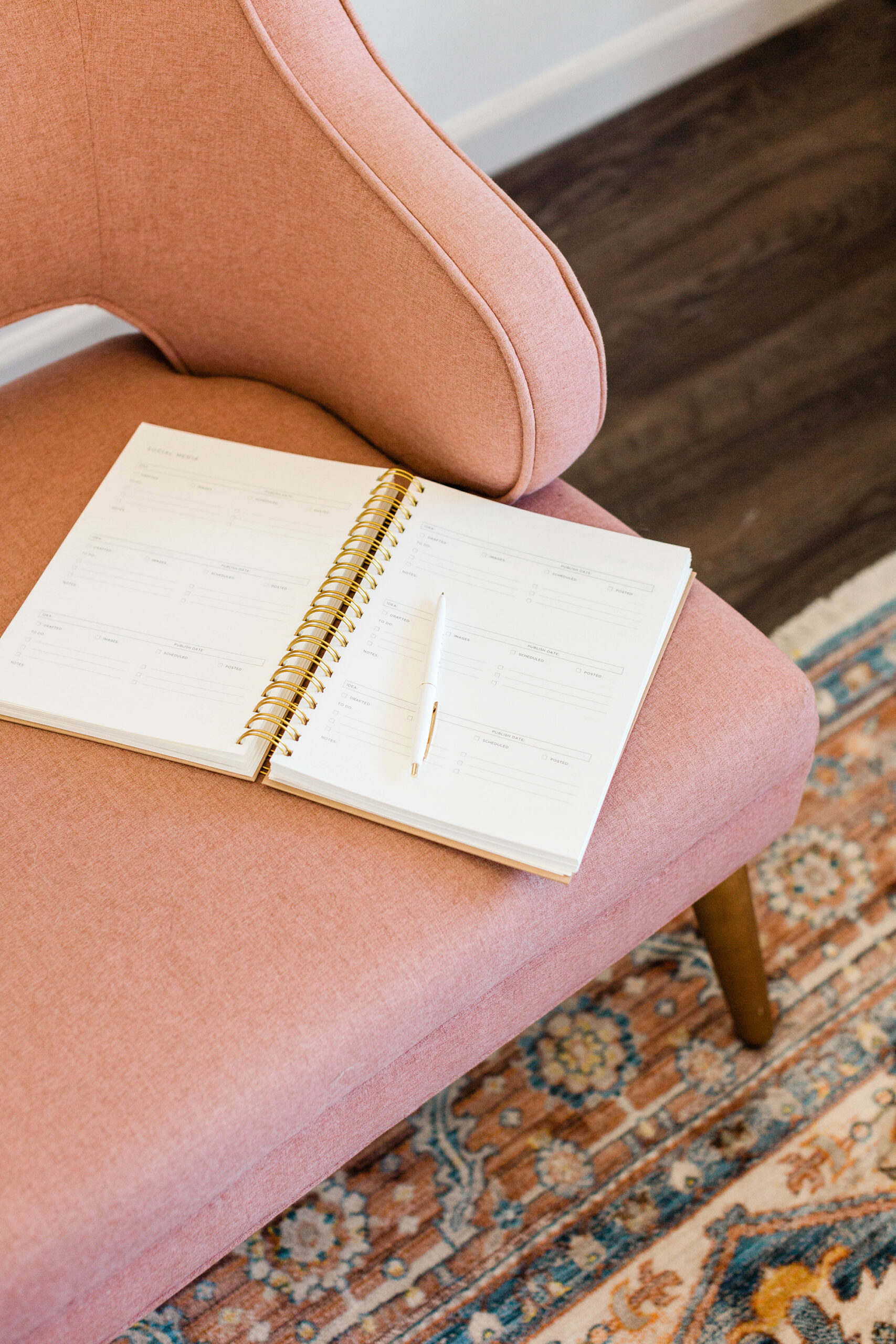 open notebook/journal on pink chair at home