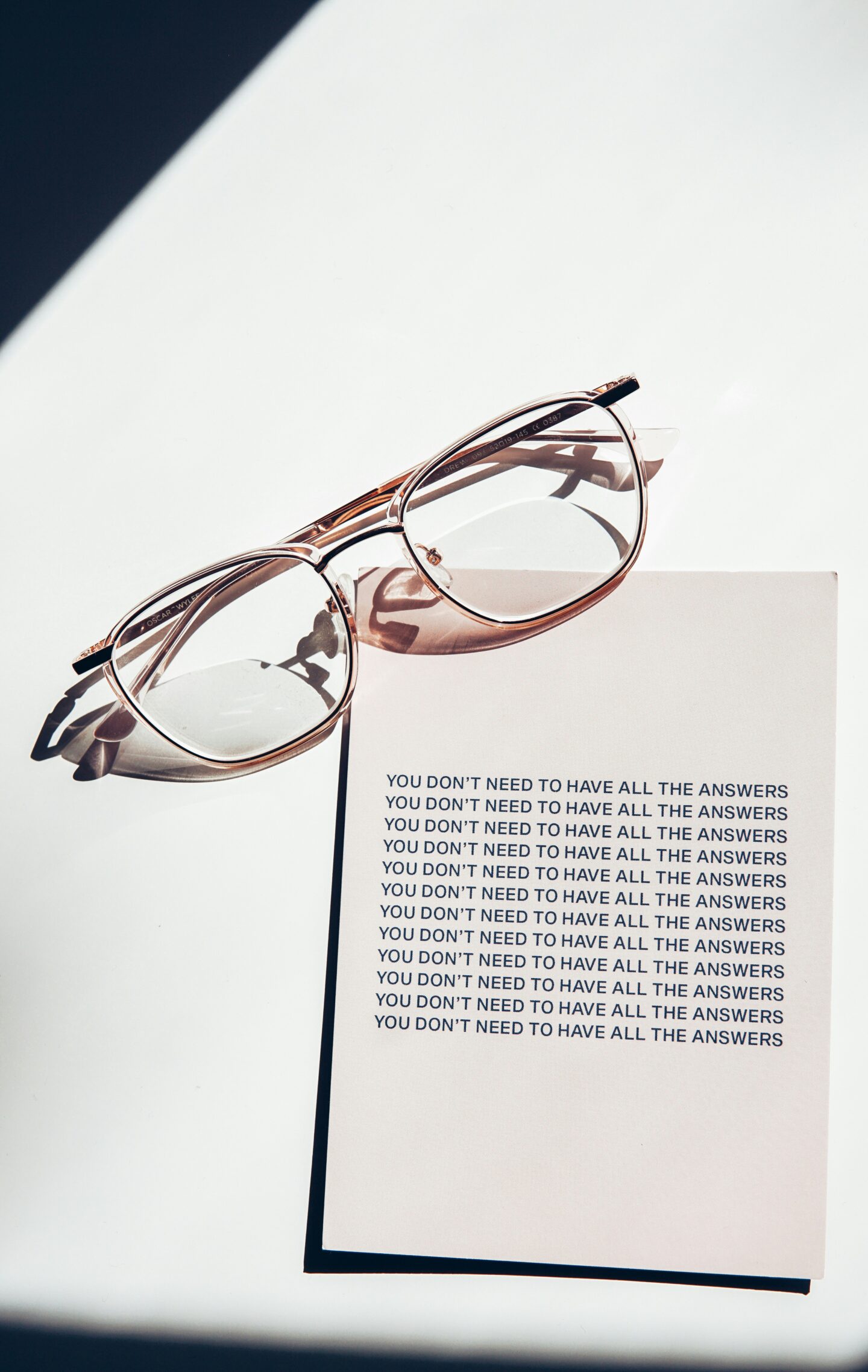 pair of glasses on a table with a quote that says 'you don't need to have all the answers'