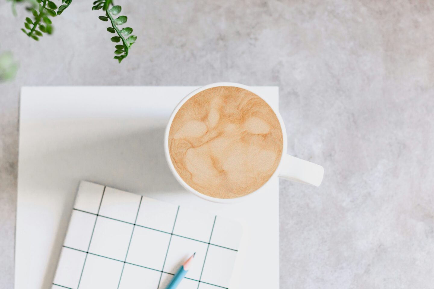 flatlay featuring coffee, paper, pencil