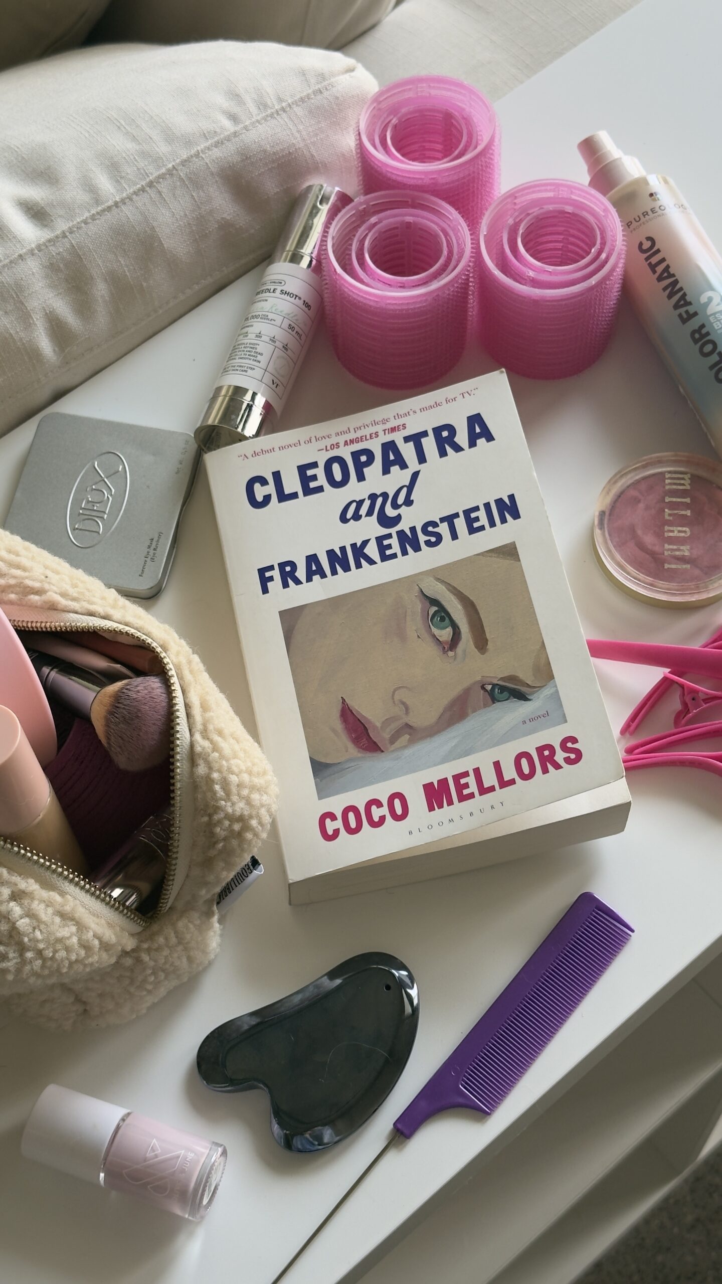 self-care items, including gua sha, book, hair rollers