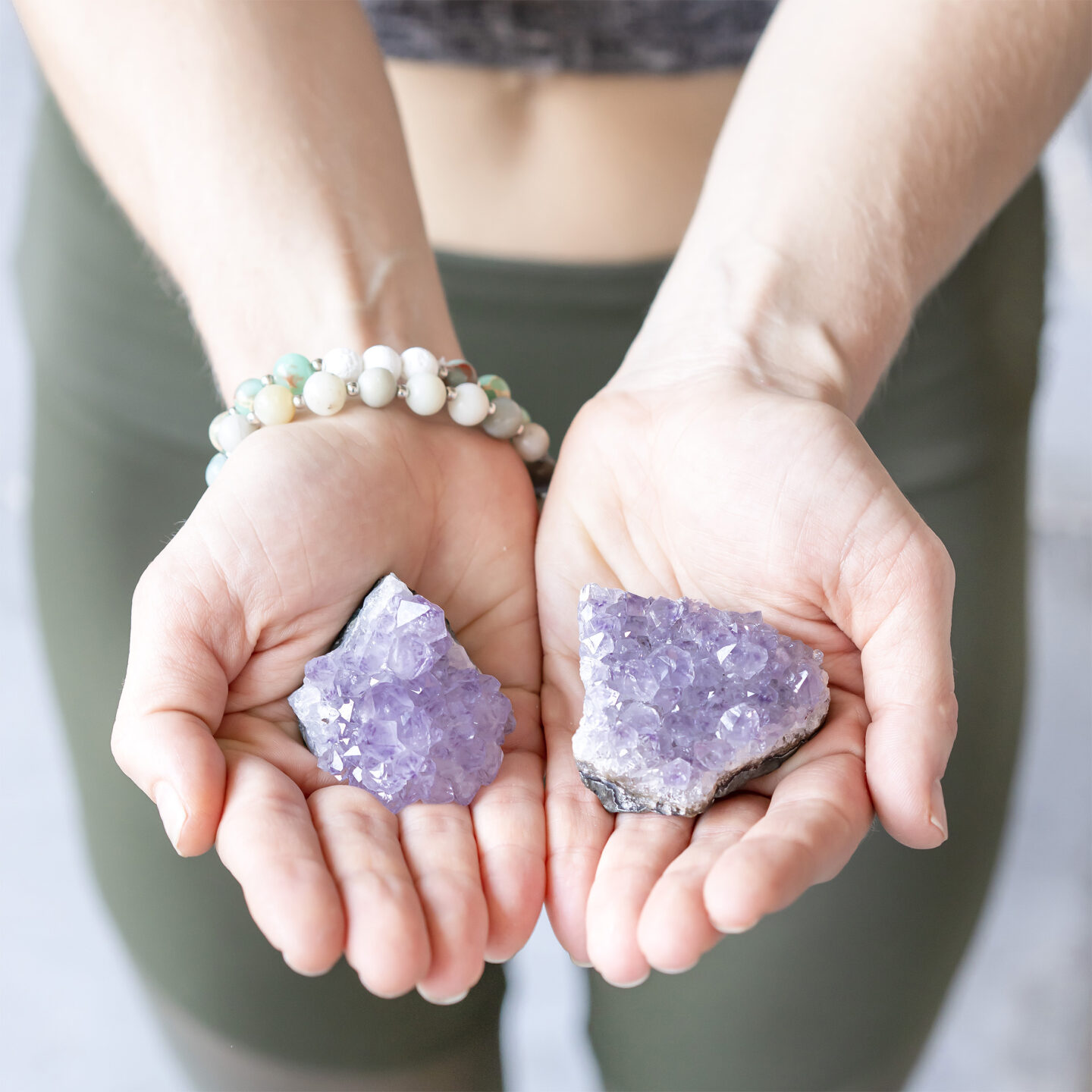 woman holding purple crystals.