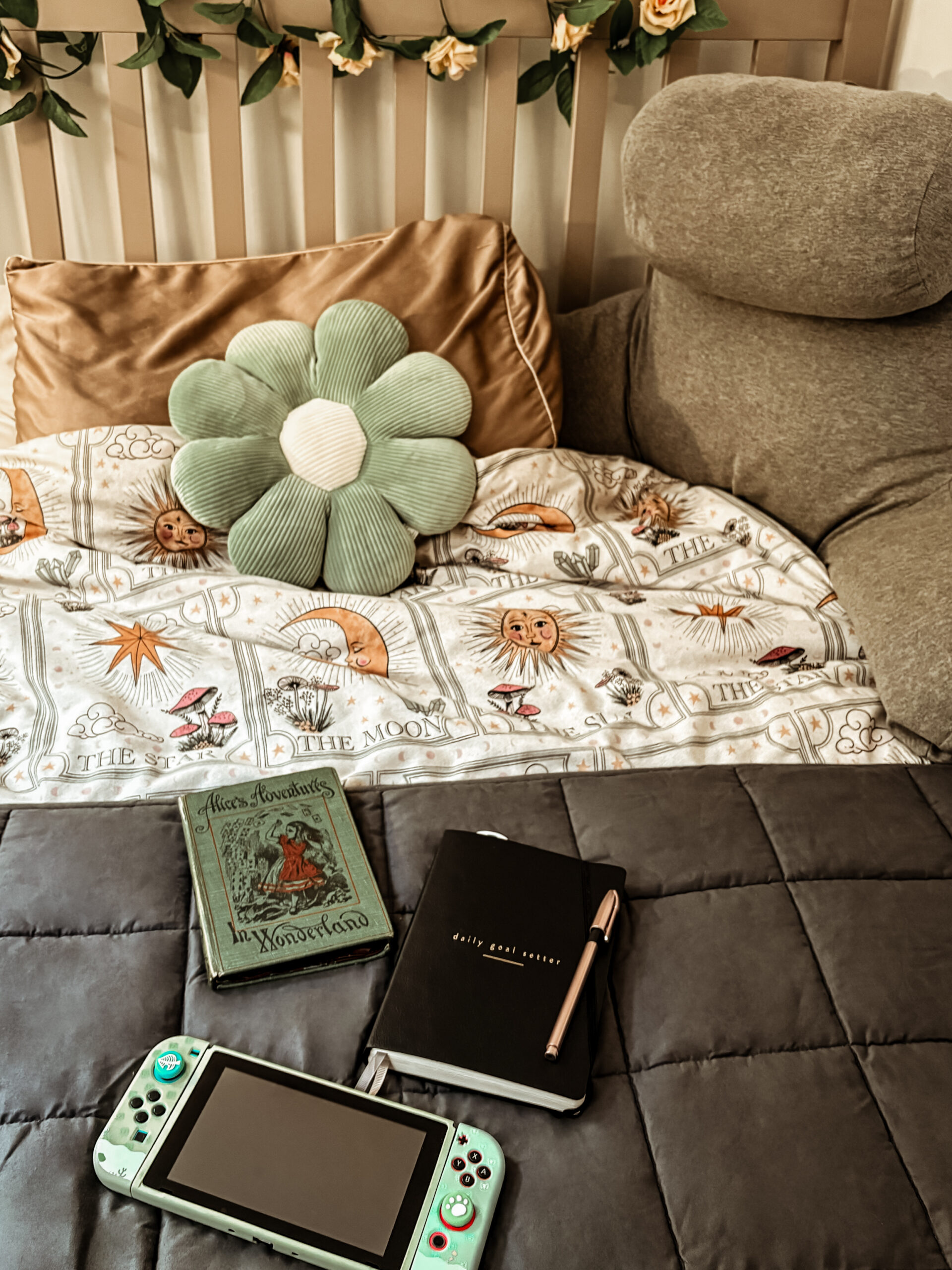 cosy autumn bedroom with self-care activities: nintendo switch, gratitude journal and kindle.