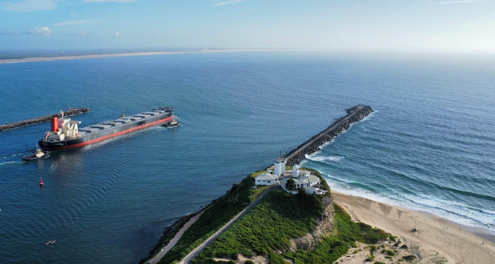 Newcastle Australia harbour at sunrise with empty beaches in the distance