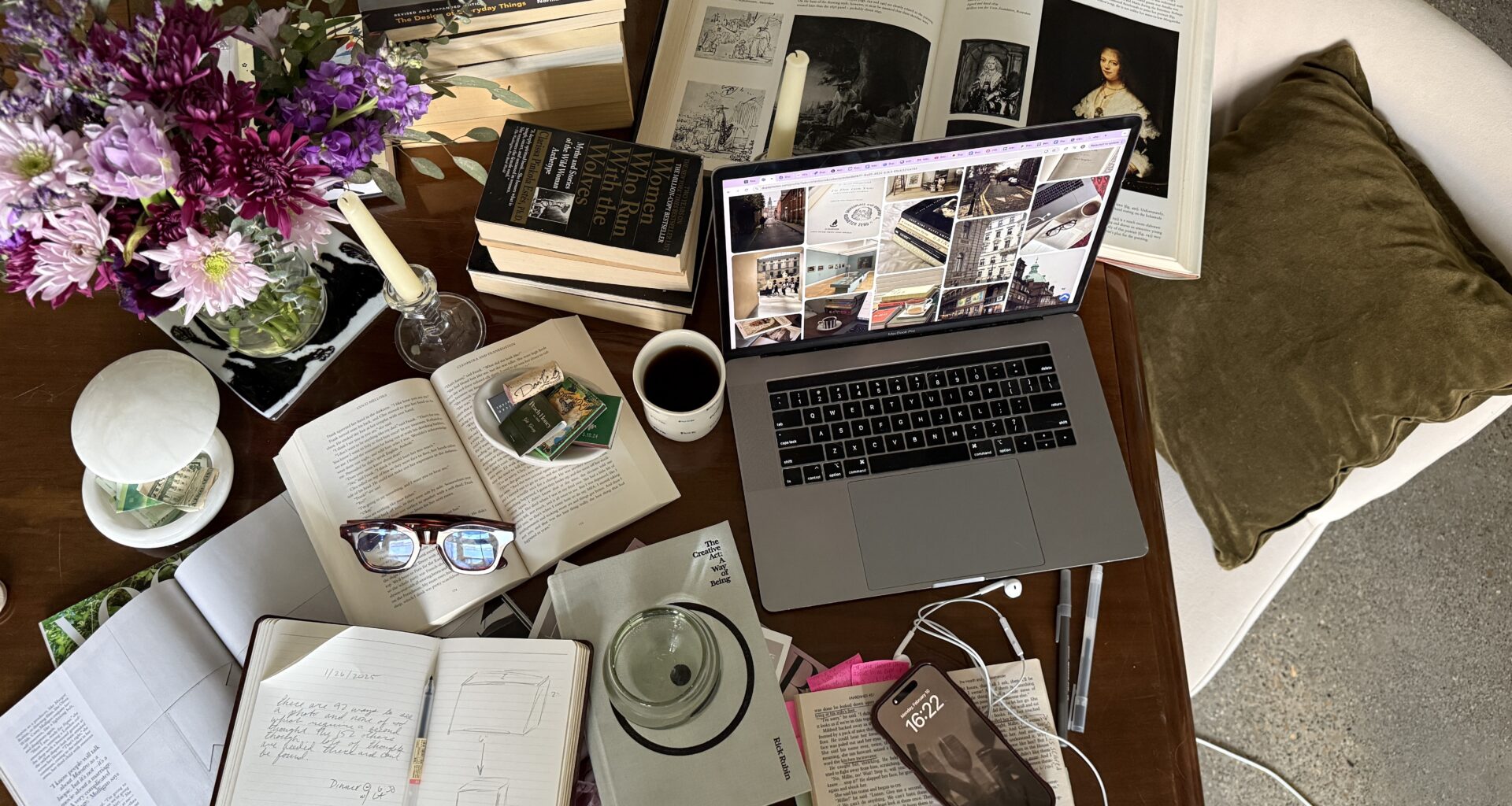 desk with notebooks coffee and laptop doing research