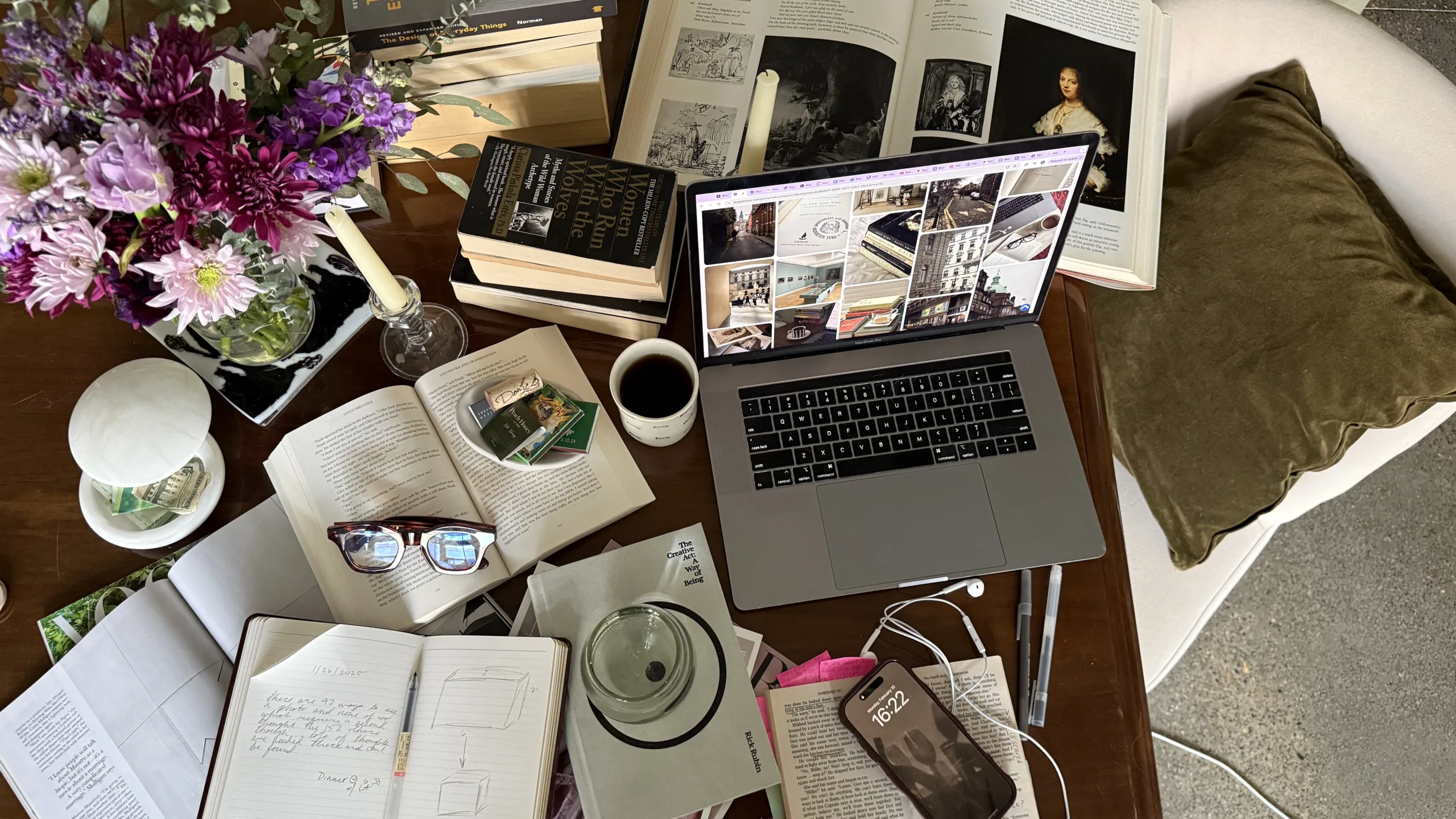 desk with notebooks coffee and laptop doing research