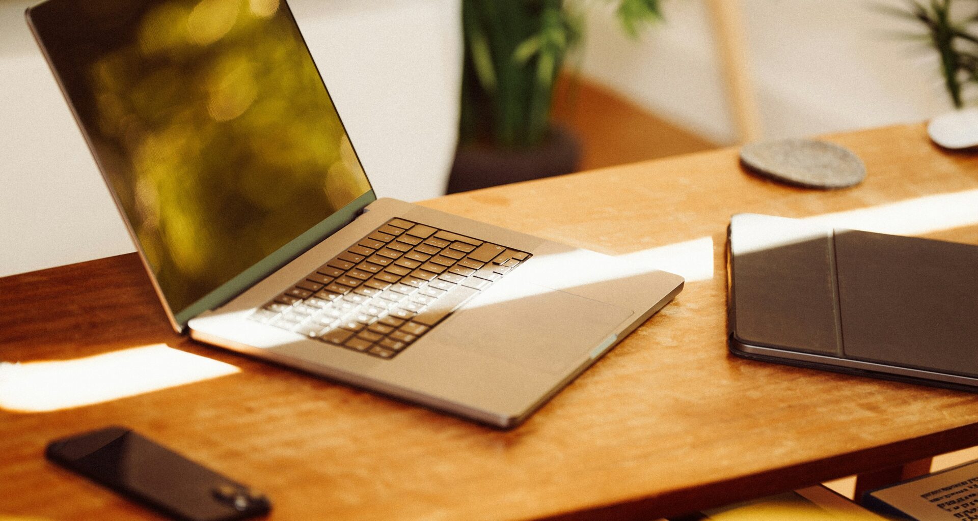 laptop on desk with phone