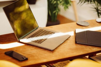 laptop on desk with phone