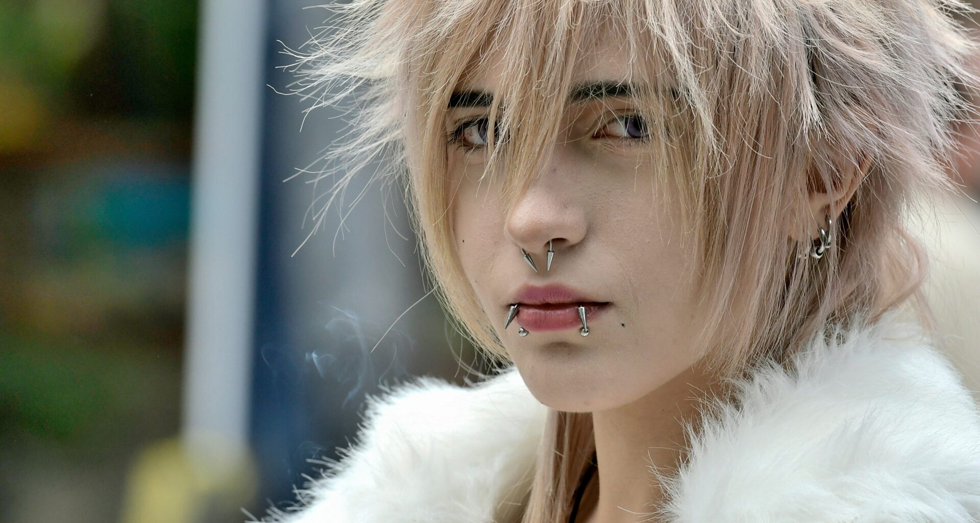 person with facial piercings